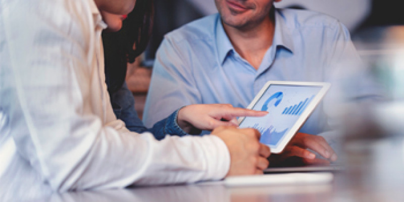 Two people looking at a tablet