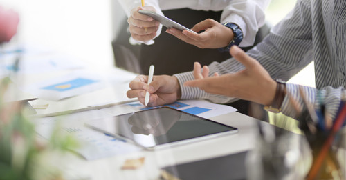 People using a tablet with stylus.