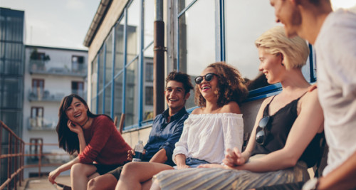 People sitting on an apartment balcony