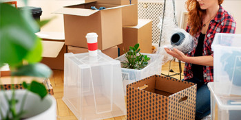 Woman packing removalist boxes