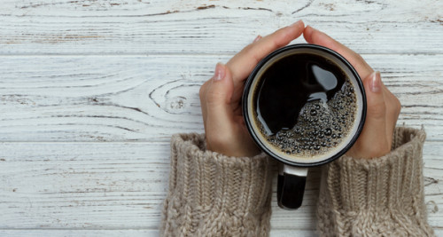 Hands holding a cup of coffee