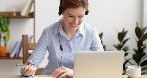 Woman watching a laptop with headphones