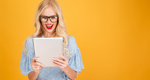 Happy woman looking at tablet