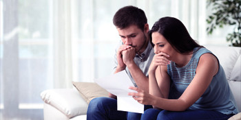 Man and a woman worrying about bills