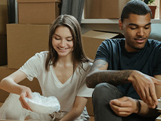 Interracial couple unpacking boxes