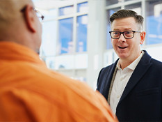 Man with surprised expression while in conversation with person.